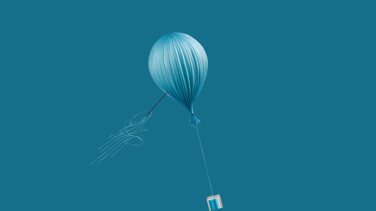 A blue balloon being punctured by a needle and losing air